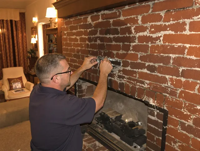 Old Saybrook Chimney Sweep expert fixing a fireplace in Old Saybrook, CT